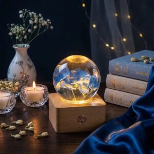 Blue hydrangea lamp with real preserved hydrangea flowers inside a clear resin sphere on a natural wooden LED base