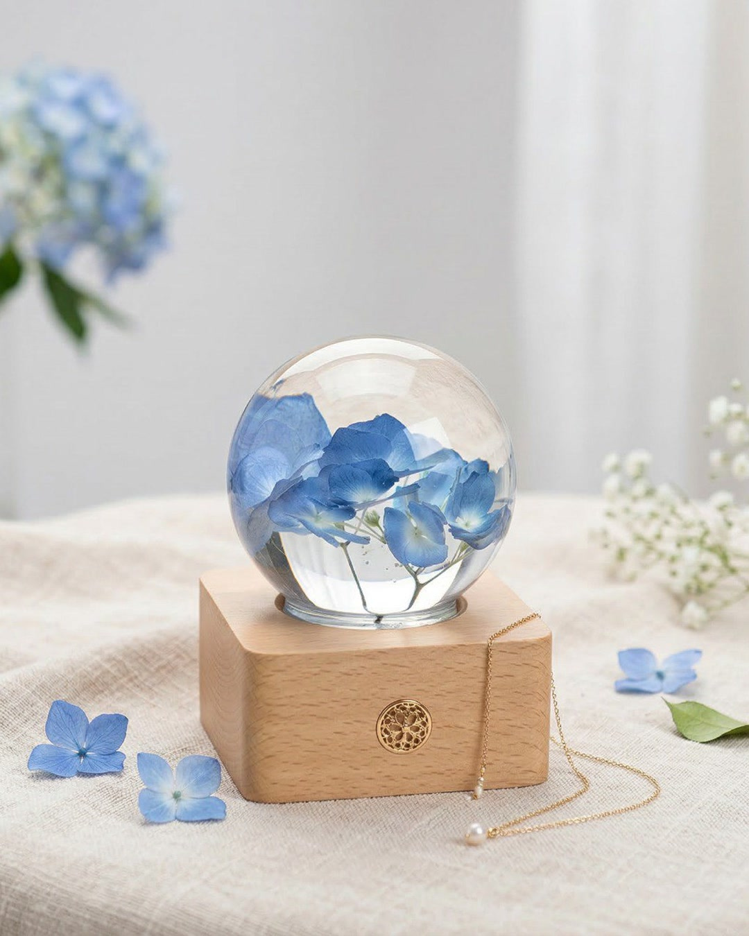 Blue hydrangea resin sphere lamp glowing on a bedside table